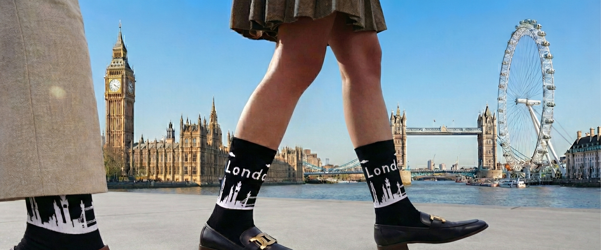 Person wearing socks with London designs in front of iconic London landmarks.