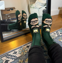 Alan Carr Traitors socks worn on both feet in front of a mirror | Stand4 Socks