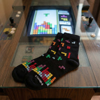 Black Arcade Game Block socks displayed on a retro arcade machine | Stand4 Socks