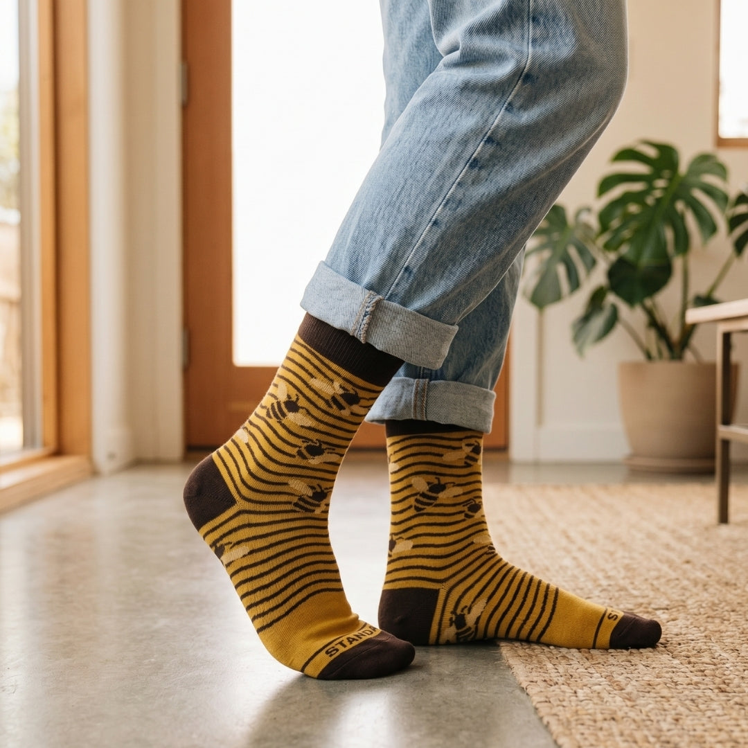Yellow Bee Lines socks worn with rolled blue jeans indoors | Stand4 Socks