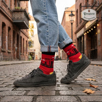 Red Berlin Skyline socks worn with black shoes on a cobbled city street | Stand4 Socks