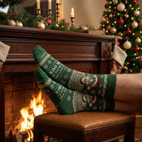 Green Christmas Theroux socks worn beside a fireplace and Christmas tree | Stand4 Socks