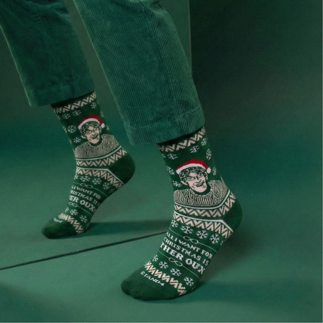 Green Christmas Theroux socks worn with cropped trousers in a green studio | Stand4 Socks