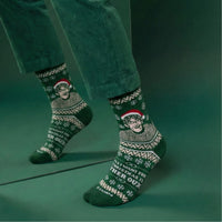 Green Christmas Theroux socks worn with cropped trousers in a green studio | Stand4 Socks