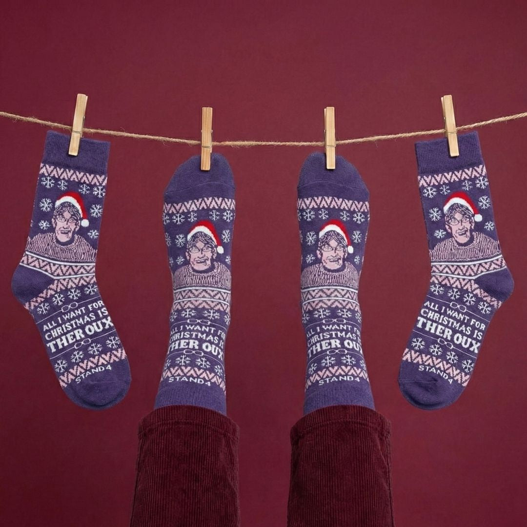 Purple Christmas Theroux socks hanging from a festive clothesline | Stand4 Socks