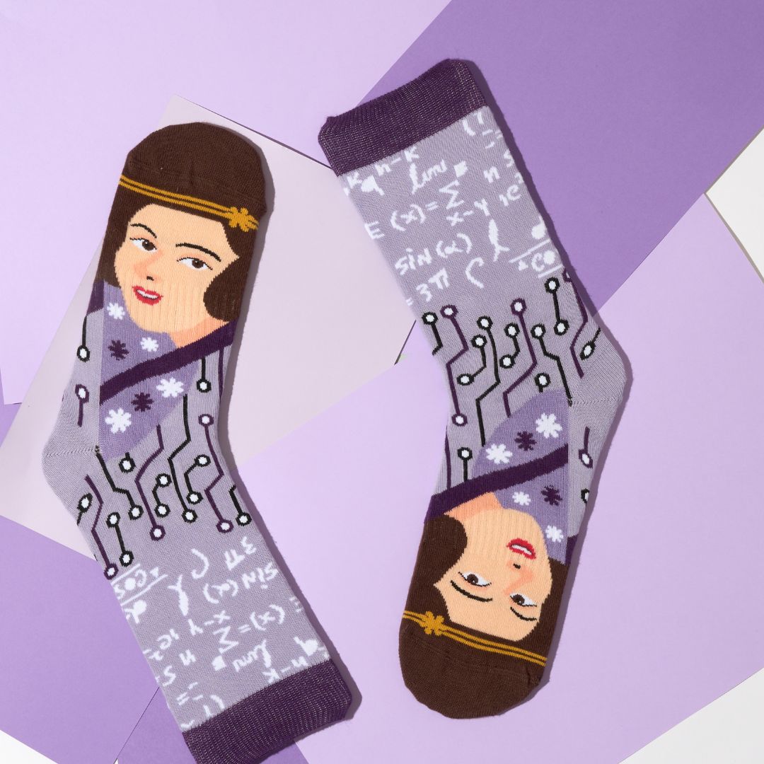 Ada Lovelace portrait crew socks arranged on a purple geometric background | Stand4 Socks