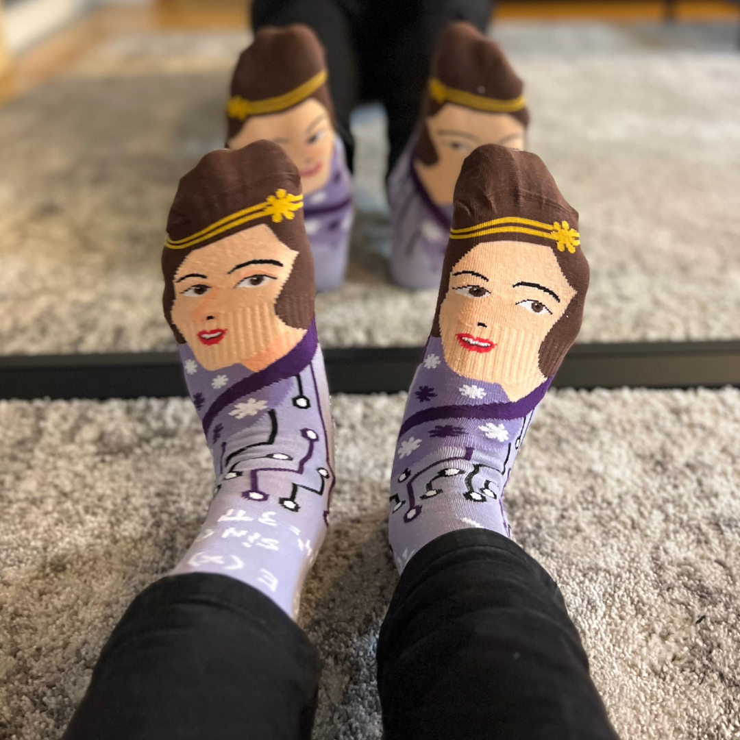Purple Ada Lovelace crew socks worn on both feet in front of a mirror | Stand4 Socks
