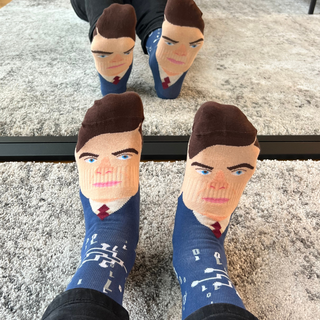 Alan Turing portrait socks worn on both feet in front of a mirror | Stand4 Socks