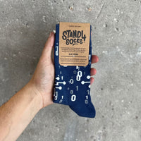 Alan Turing sock in packaging held against a grey background | Stand4 Socks buy one, give one to someone homeless