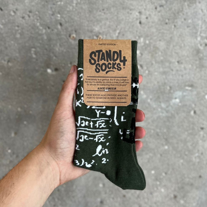 Albert Einstein sock in packaging held against a grey background | Stand4 Socks buy one, give one to someone homeless