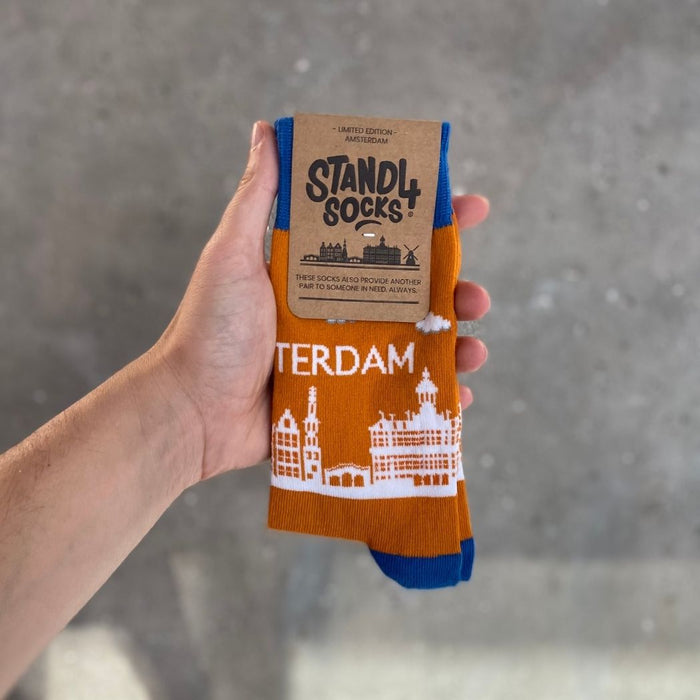 Amsterdam Skyline sock in packaging held against a grey background | Stand4 Socks buy one, give one to someone homeless