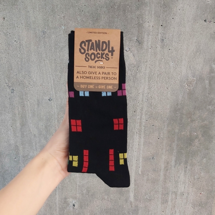 Black Arcade Game Block sock in packaging held against a grey background | Stand4 Socks buy one, give one to someone homeless