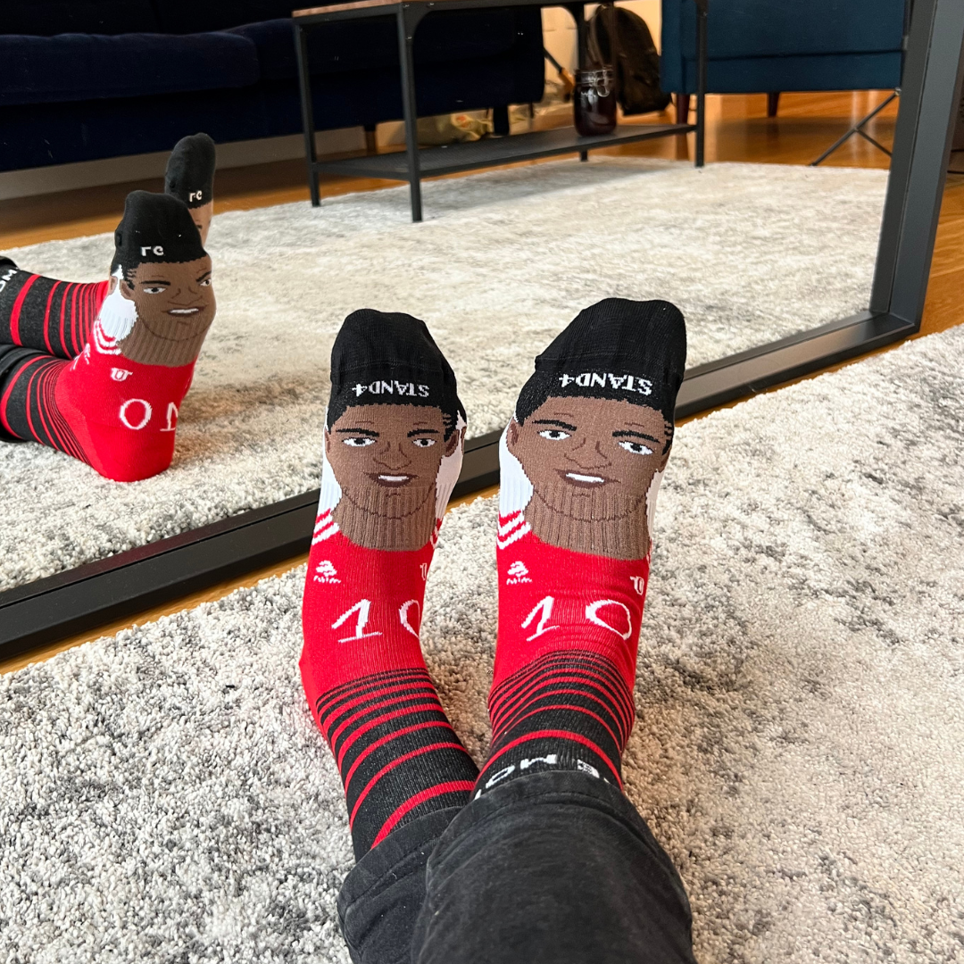 Be More Rashford portrait socks worn on both feet in front of a mirror | Stand4 Socks