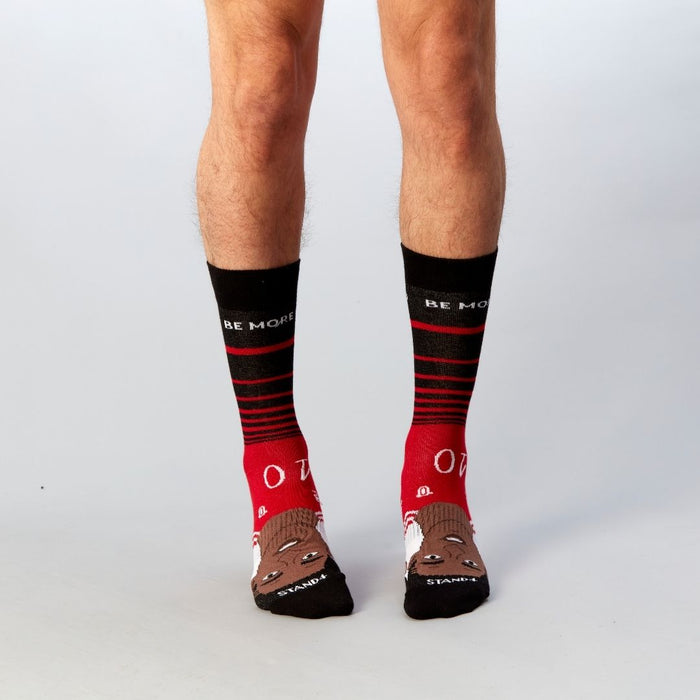 Red and black Be More Rashford socks worn by a standing model | Stand4 Socks