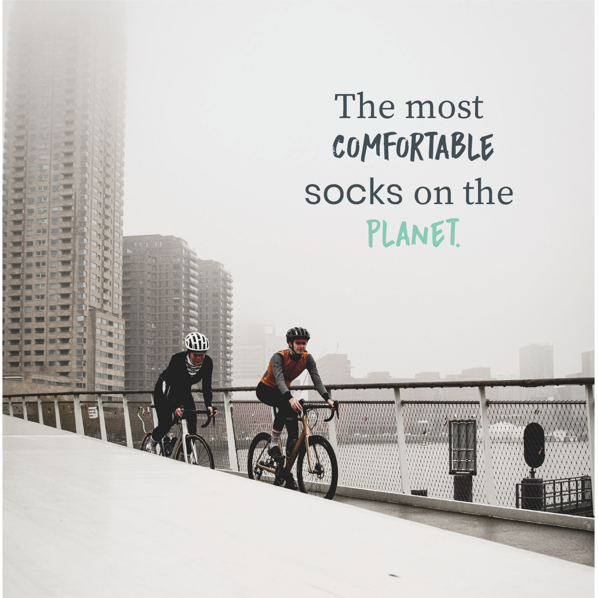 Two cyclists riding through a city in a COOLMAX performance sock campaign | Stand4 Socks