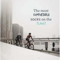 Two cyclists riding through a city in a COOLMAX performance sock campaign | Stand4 Socks